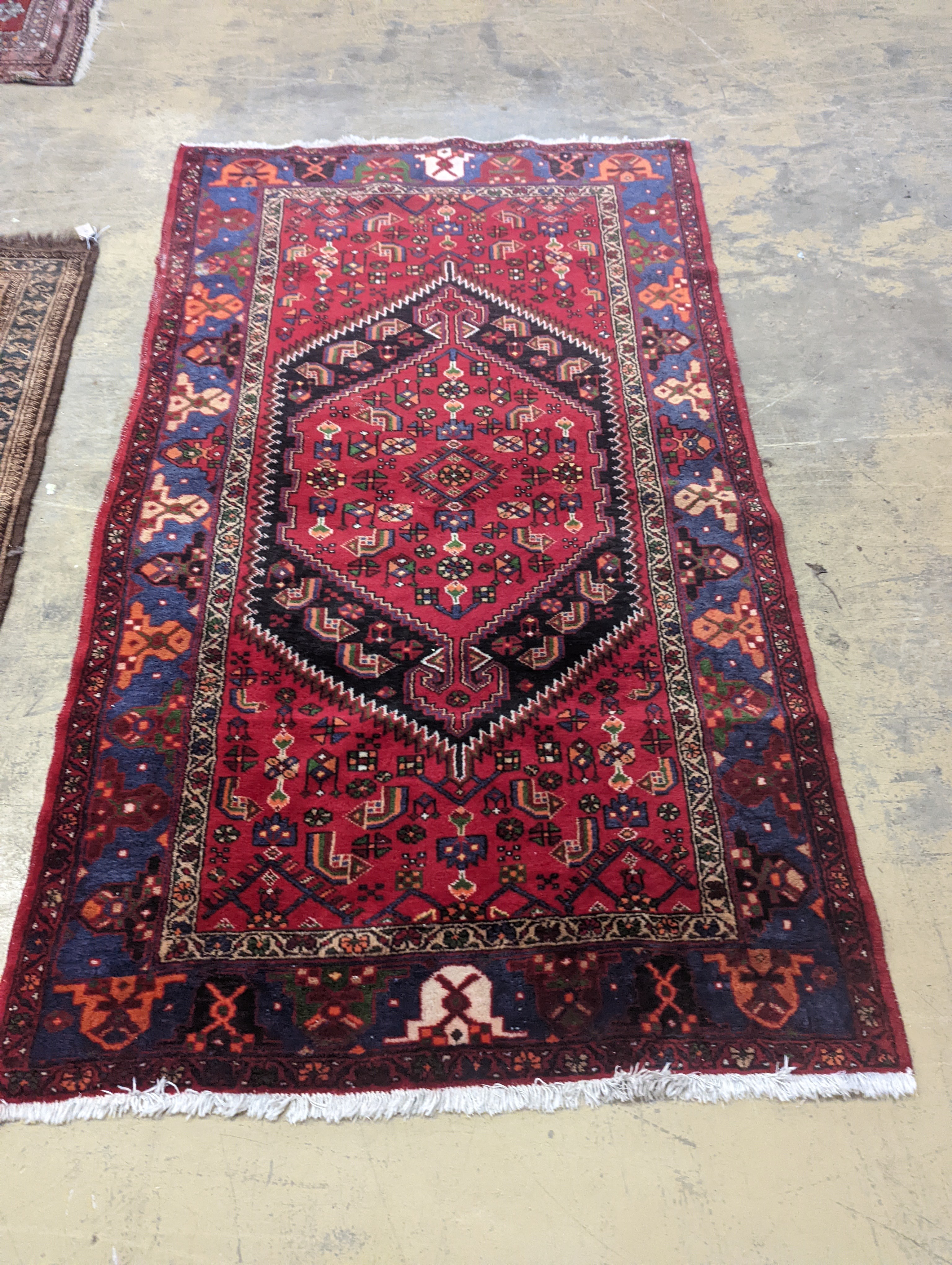 A Hamadan red ground rug, 220 x 130cm